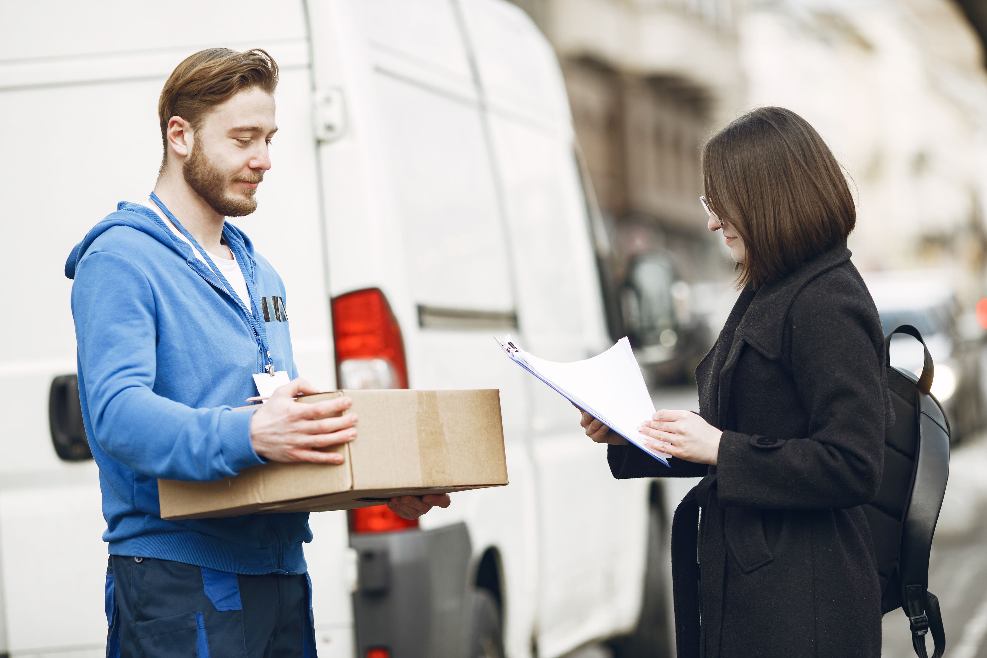 Professional courier handling a delivery in a city environment